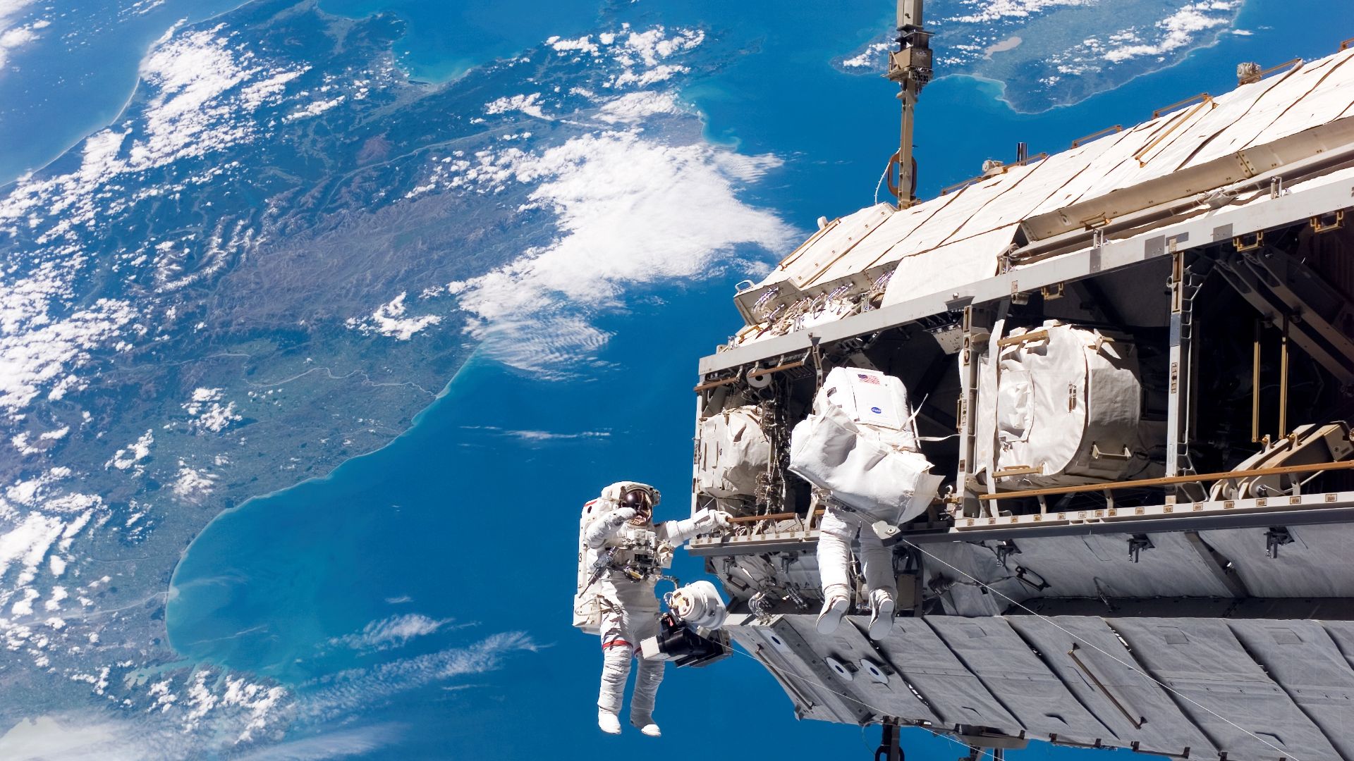 STS-116 Shuttle Mission Imagery
Backdropped by a colorful Earth, NASA astronaut Robert L. Curbeam, Jr. (left) and European Space Agency (ESA) astronaut Christer Fuglesang, both STS-116 mission specialists, participate in the mission's first of three plann