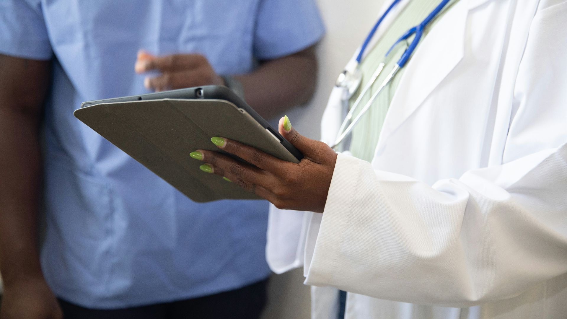 a doctor showing a patient something on the tablet