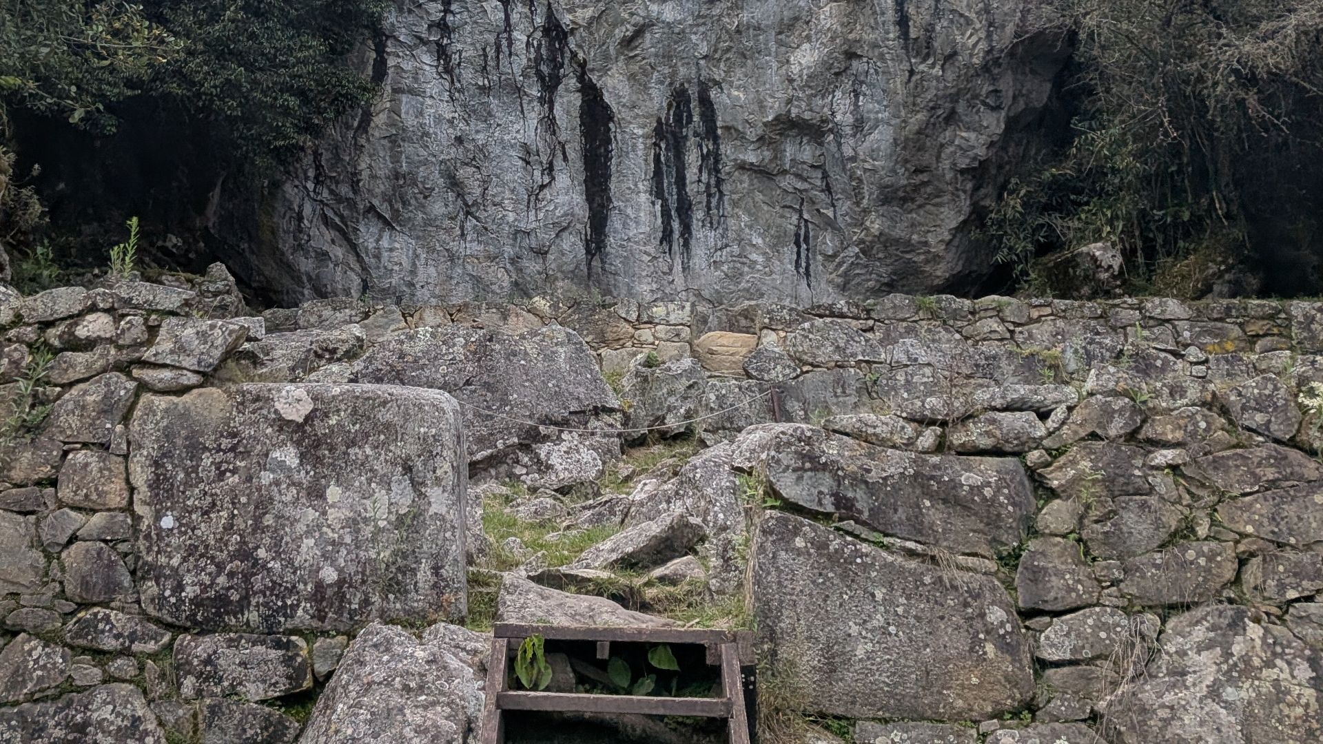 A large rock face at the side of the path that leads to Machu Picchu when coming down the inca trail from the sun gate
