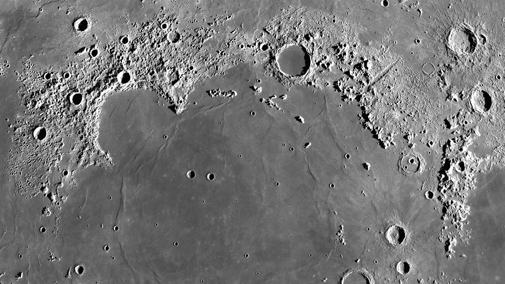 Mare Imbrium on the Moon. Mosaic of photos by Lunar Reconnaissance Orbiter, made with Wide Angle Camera. Size of the image is 1100×1100 km, north is up. A map in orthographic projection, centered at 34.7°N, 14.9°W (but center of the cropped piece is somew
