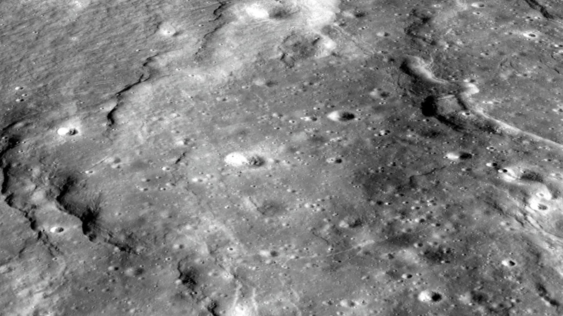 Lobate scarps - like those shown here on the floor of the farside crater d'Alembert - are not large, but they tell us much about how hot the Moon was when it was born and its ongoing thermal evolution. Image width is about four kilometers. [NASA/GSFC/Ariz
