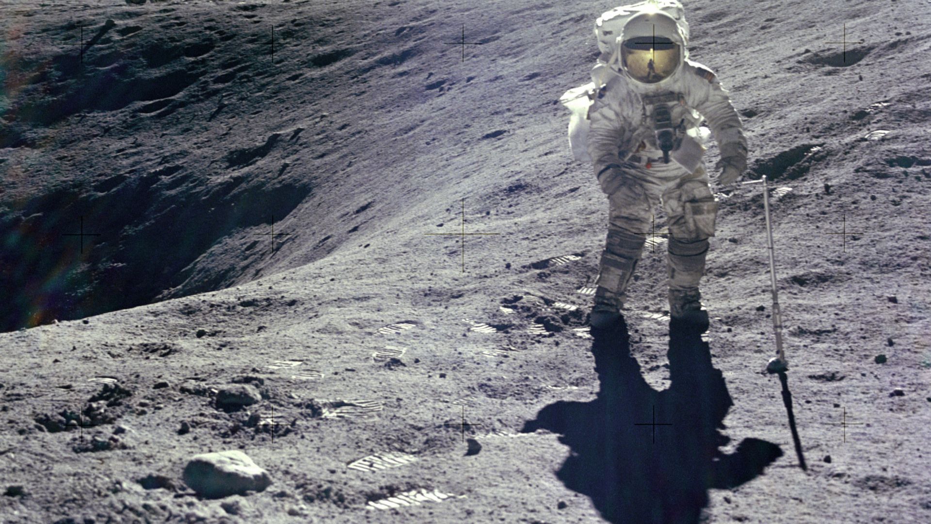 Astronaut Charles M. Duke Jr., Lunar Module pilot of the Apollo 16 mission, is photographed collecting lunar samples at Station no. 1 during the first Apollo 16 extravehicular activity at the Descartes landing site. 
This picture, looking eastward, was ta