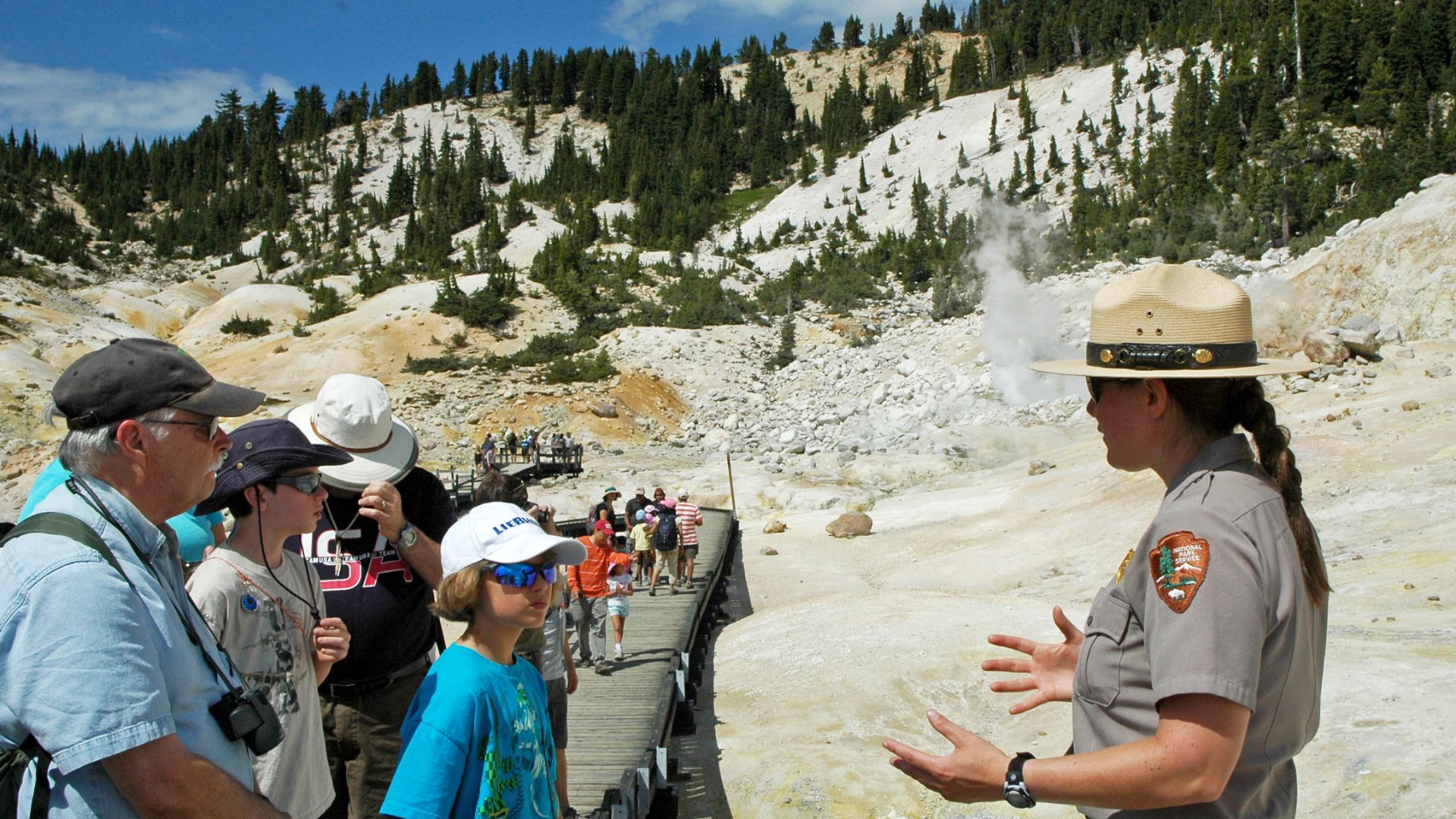 park ranger talking to a group of visitors on a boardwalk over steaming water
Rangers offer a variety of programs throughout the year, like talks at Bumpass Hell.
Keywords: ranger; ranger program; Bumpass Hell; hydrothermal; Bumpass Hell program; interpre