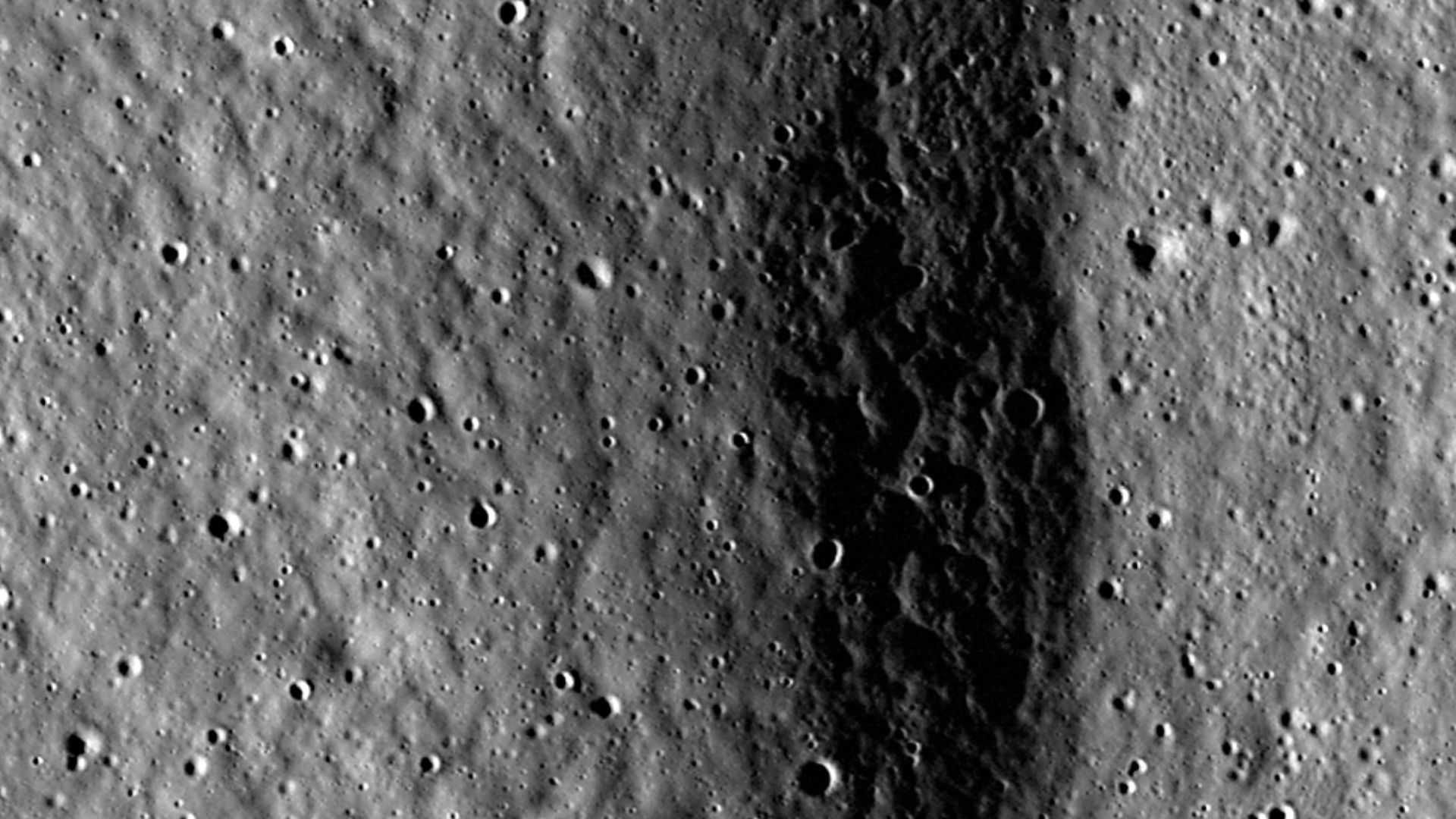 A North-South trending lobate scarp lies within Xenophanes crater. LROC NAC M118031613LE, image width is 600 m [NASA/GSFC/Arizona State University].