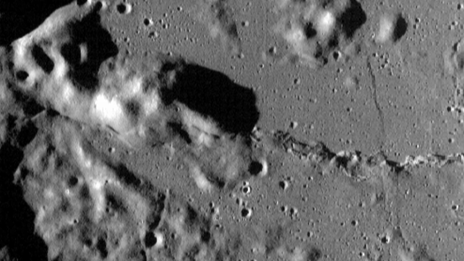 Marine wrinkle ridge (at the right) which transits into a lobate scarp (at the left) on the western shore of Mare Serenitatis (see Clark et al., 2017). Photo by Lunar Reconnaissance Orbiter, made with Wide Angle Camera on 6 January 2010 from altitude 41 k