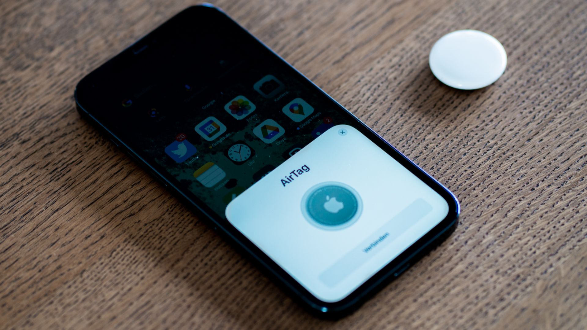 An Apple AirTag being set up using an iPhone 12 Pro Max