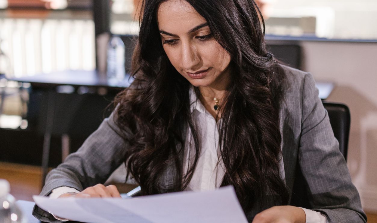 Professional woman in an office setting reviewing documents