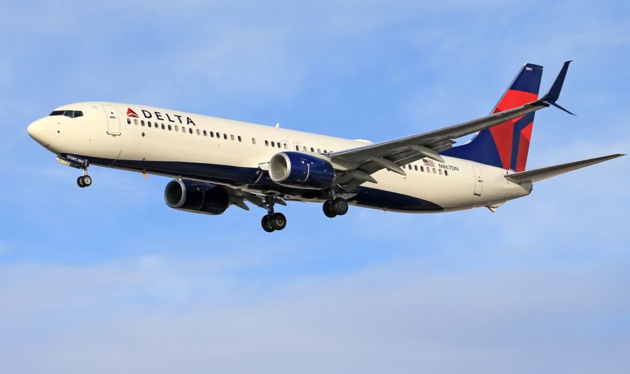 Delta airline passenger plane flying in clear blue sky. Ideal for travel and transportation themes