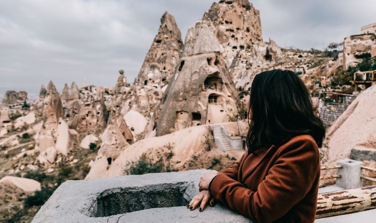 Woman overlooking unique rock formations in Goreme National Park, Cappadocia, Turkey