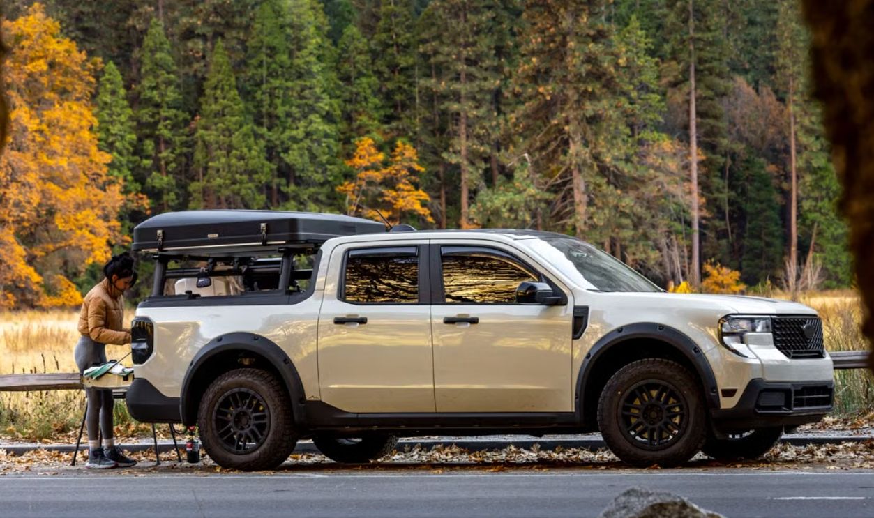 Camping adventure with a pickup truck in a scenic autumn forest setting