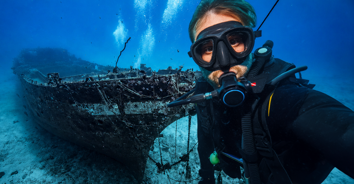 Composite of a scuba diver taking a selfie and an underwater shipwreck