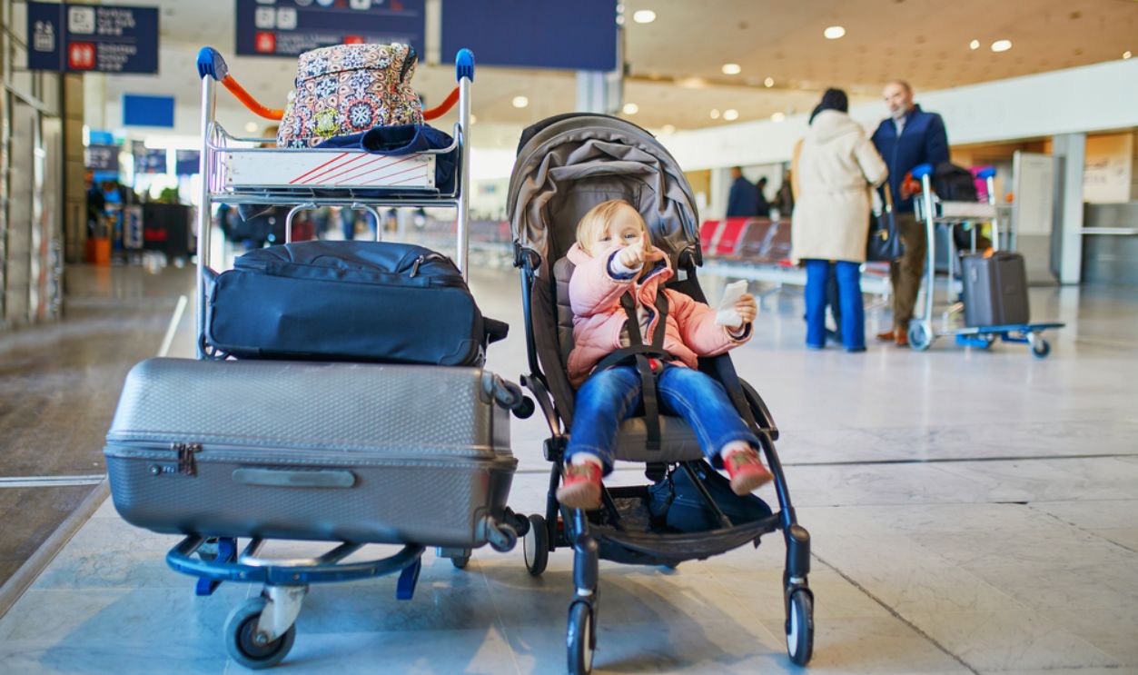 Adorable little toddler girl in international airport.