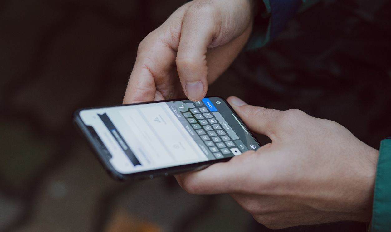 Close-up of person texting on a smartphone. Outdoor setting with wireless connectivity