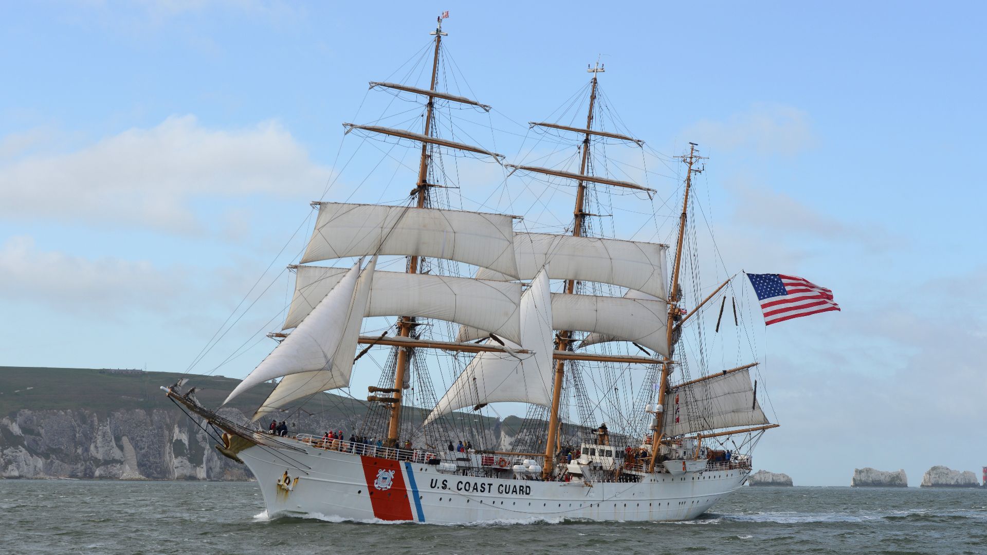 The Coast Guard Tall Ship Eagle (WIX 327) sails past the Isle of Wight while en route to Portsmouth, England, April 25, 2019. The Eagle serves as the training vessel for the cadets of the Coast Guard Academy and was conducting its 2019 summer tour. (U.S. 