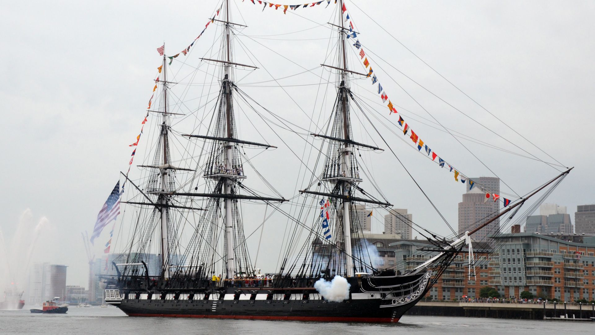 BOSTON (July 4, 2014) USS Constitution fires a 17-gun salute near U.S. Coast Guard Base Boston during the ship's Independence Day underway demonstration in Boston Harbor. Constitution got underway with more than 300 guests to celebrate America's independe