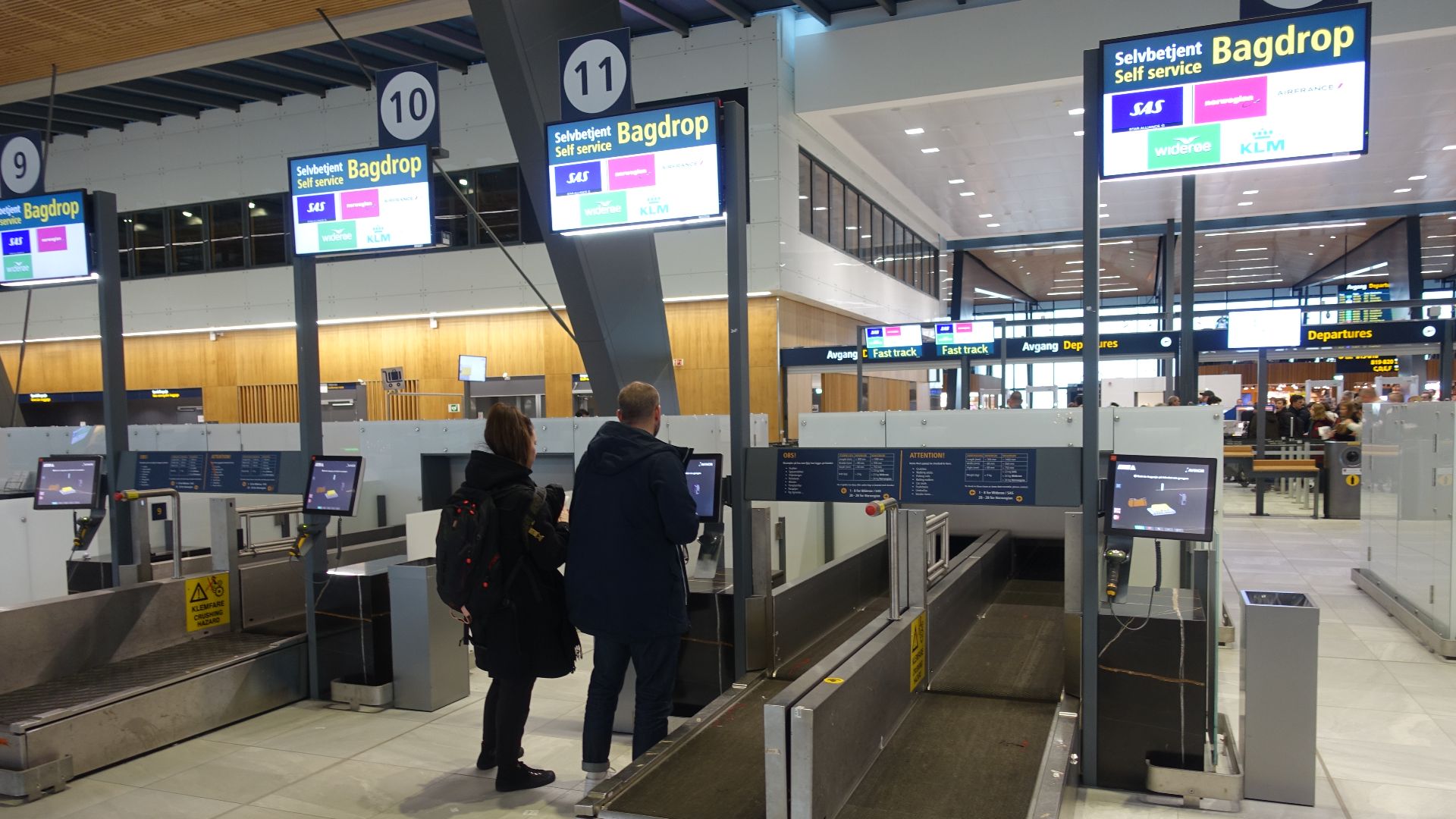 Self-service Bag drop for registration and sending checked bags and luggage: a self-check-in process allowing passengers with bags to check-in at Self Bag Drop machines where they attach the baggage tag and drop the bag at the baggage drop belt (conveyor