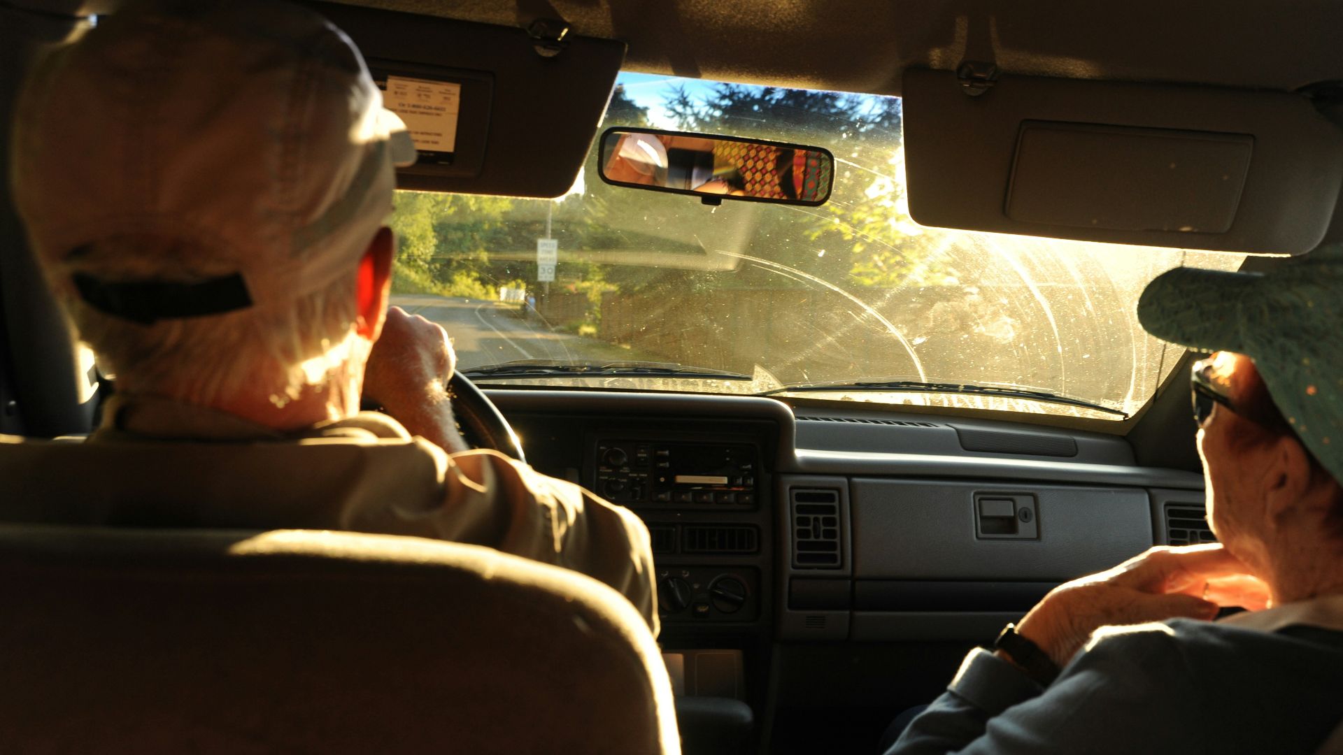 man and woman sitting on car front seat