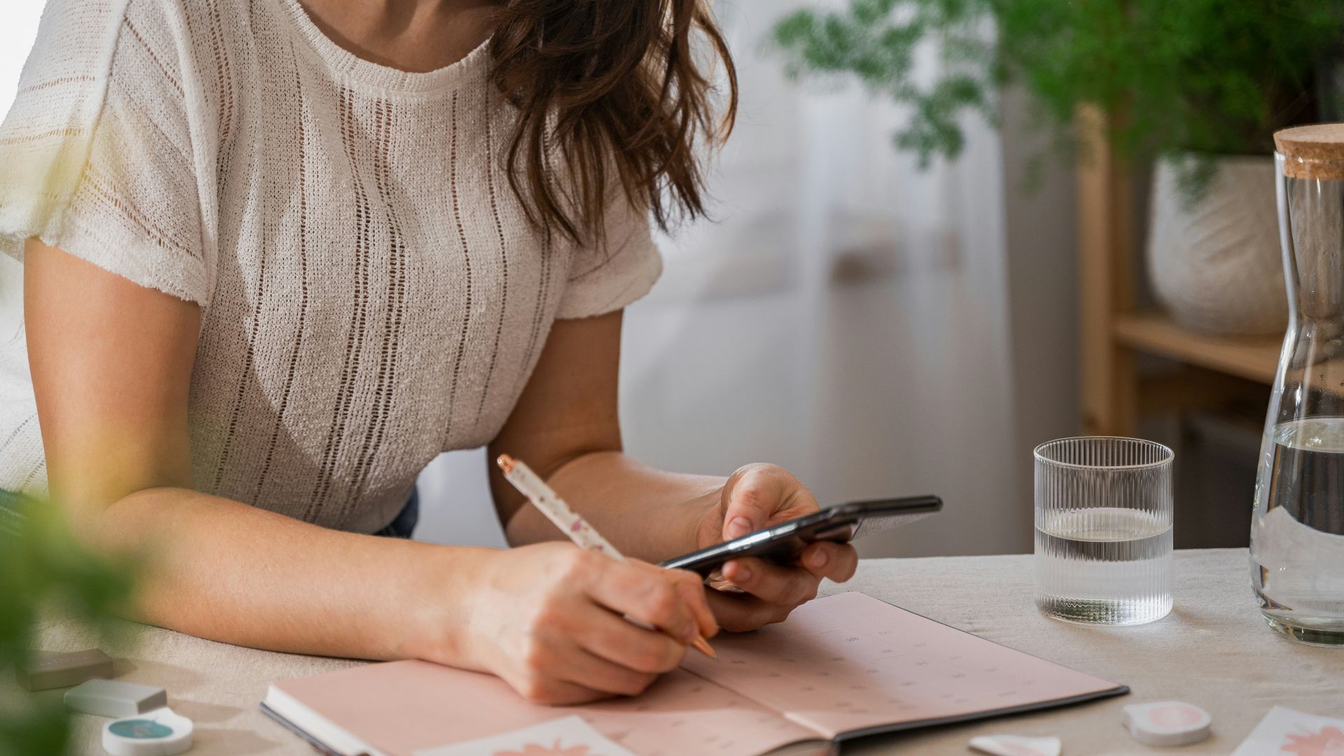 a woman writing on a piece of paper