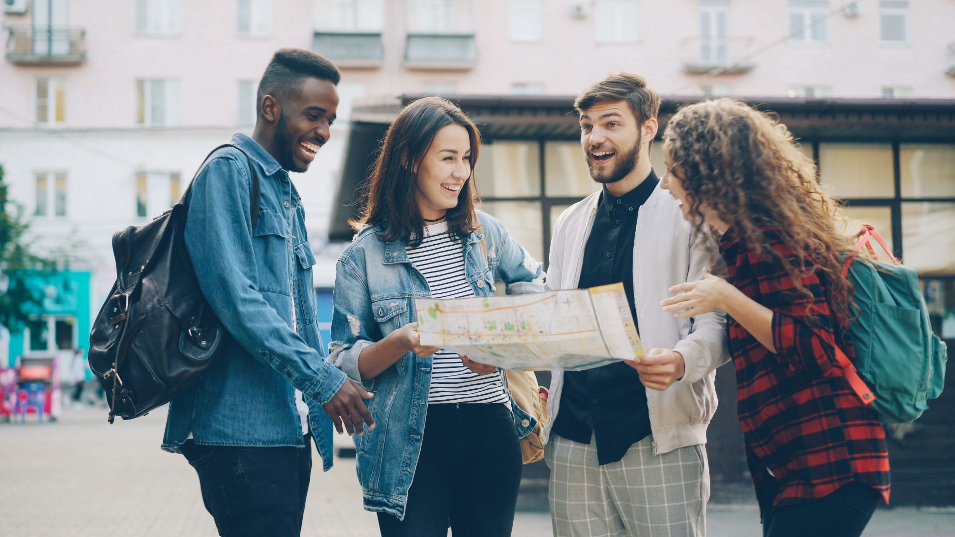 Friends look at a map, likely planning their trip.