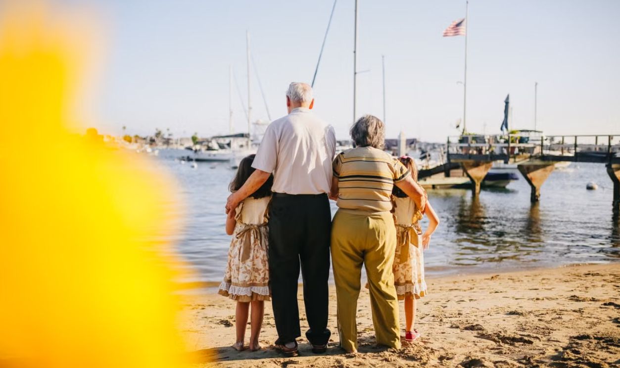 A multigenerational family enjoys a sunny day by the seaside, capturing togetherness and joy