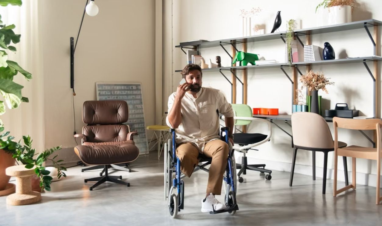 onfident bearded man in wheelchair talking on phone