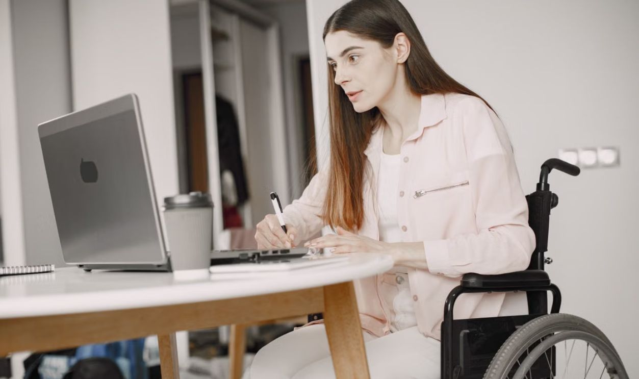 Woman in a wheelchair working remotely at home