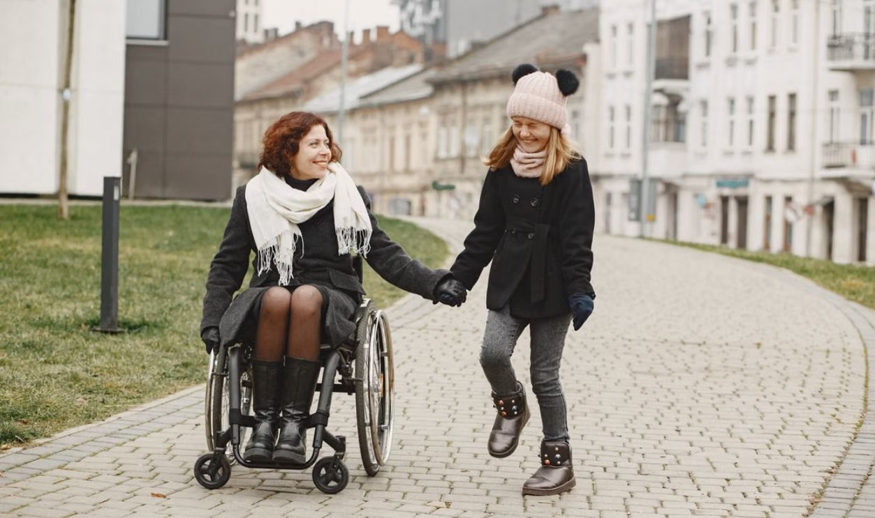 A joyful mother and daughter share a moment together on a sidewalk