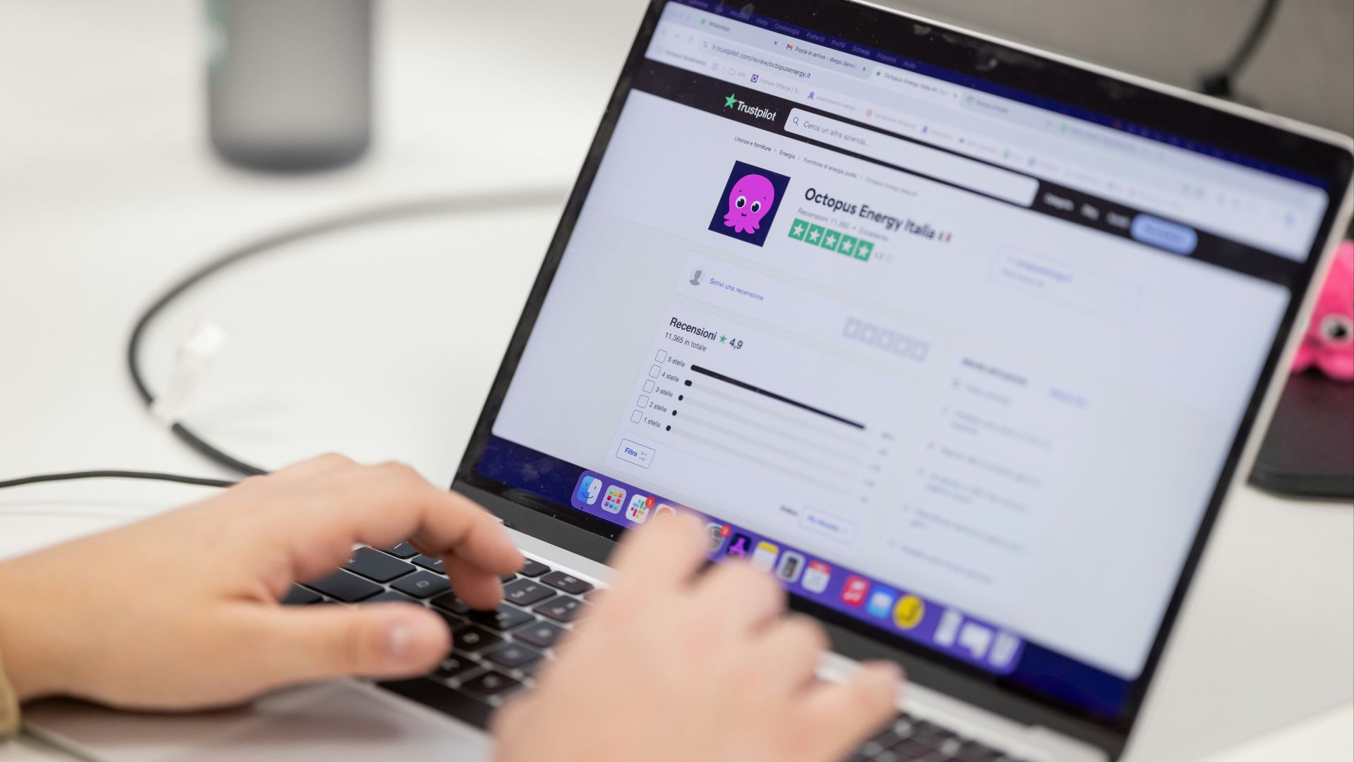 Person typing on a laptop computer screen.