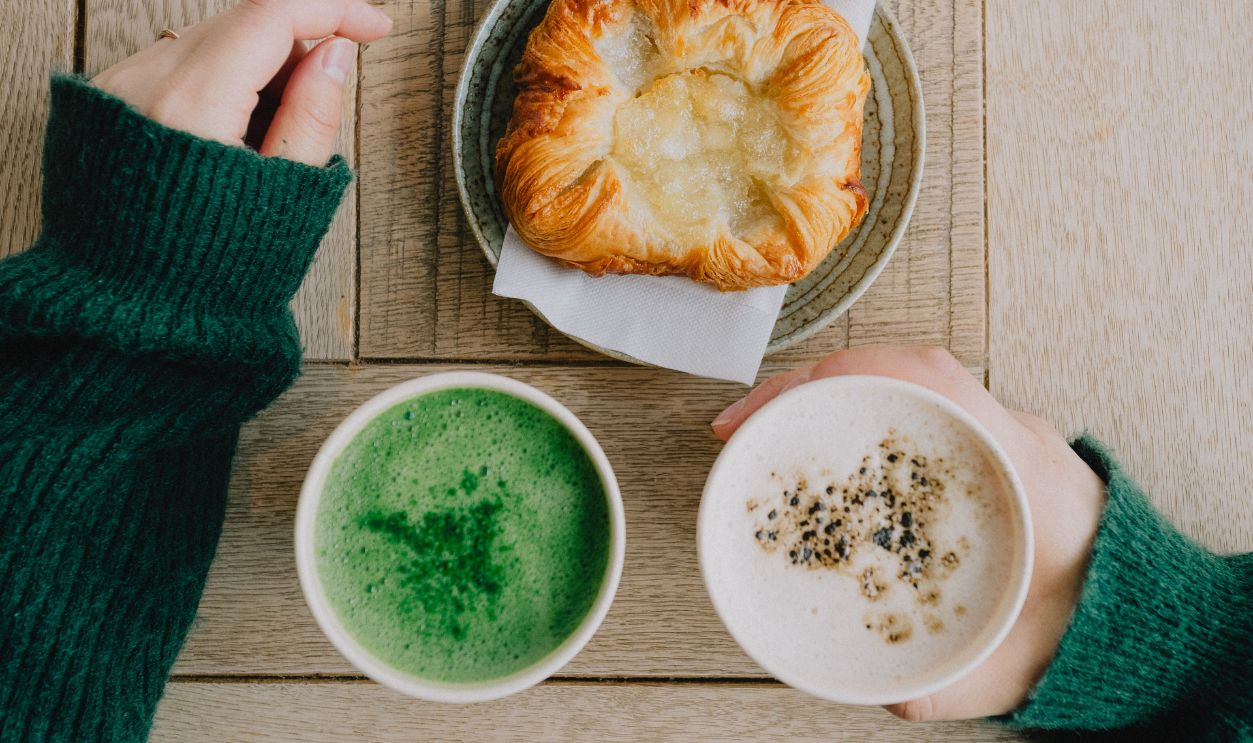 A warm cafe scene featuring a matcha latte and pastry, perfect for a cozy day in a Japanese cafe.