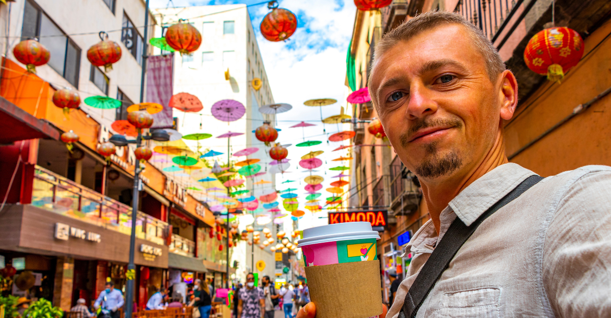 Handsome Man Tourist with Coffee in China Town Chinatown Tourist Street People Chinese Lantern Colorful Parasols and Shops in Centro Historico Mexico City Mexico.