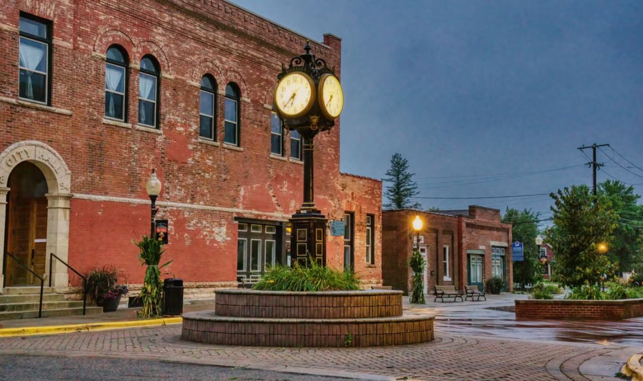 Charming brick building with unique street clock in Wabasha, Minnesota. Urban historic scene at dusk