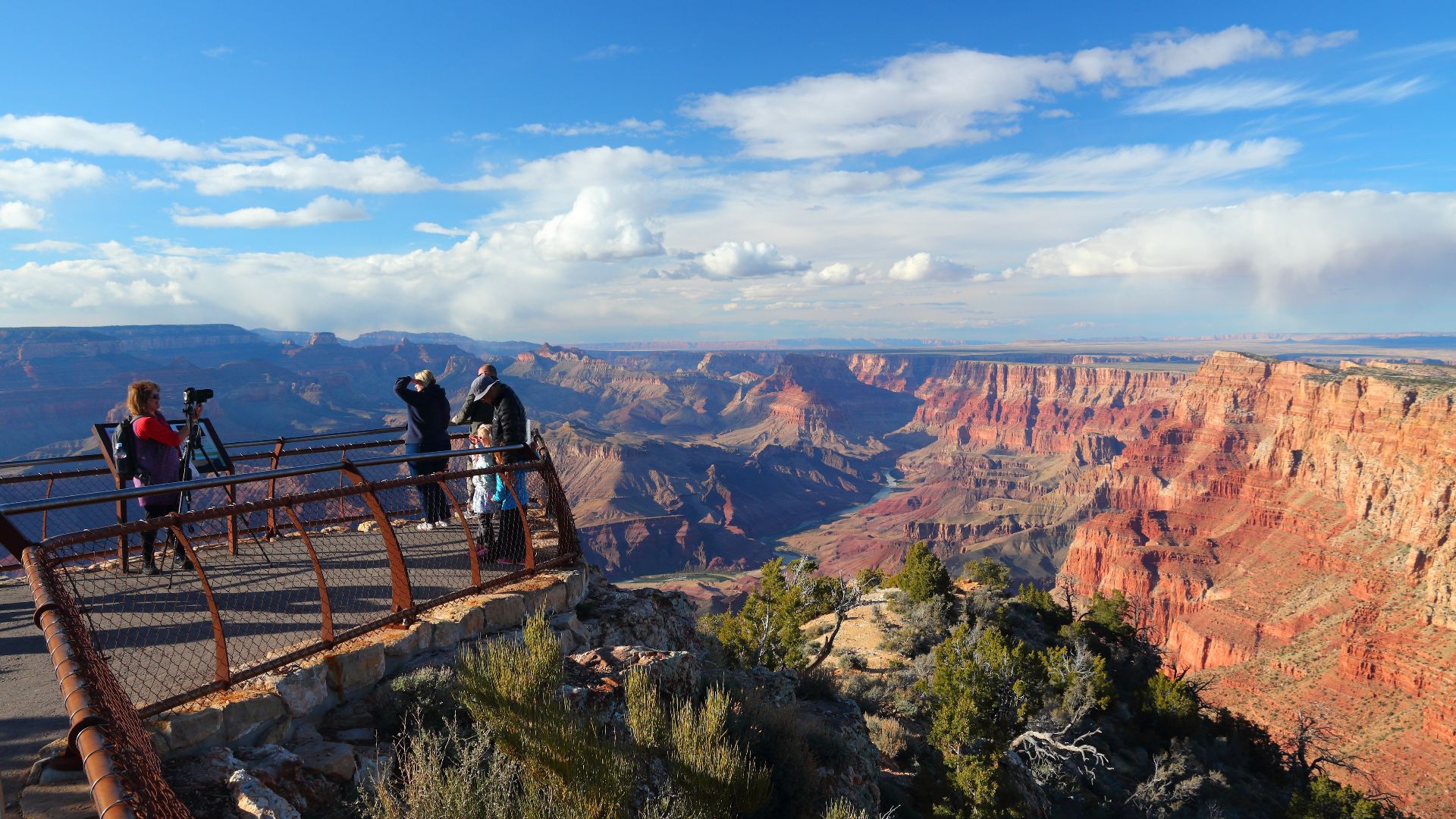 American nature. Tourists at Grand Canyon Navajo Point viewpoint terrace, Grand Canyon National Park, Arizona, USA. Late afternoon light at South Rim of Gran Canyon.
