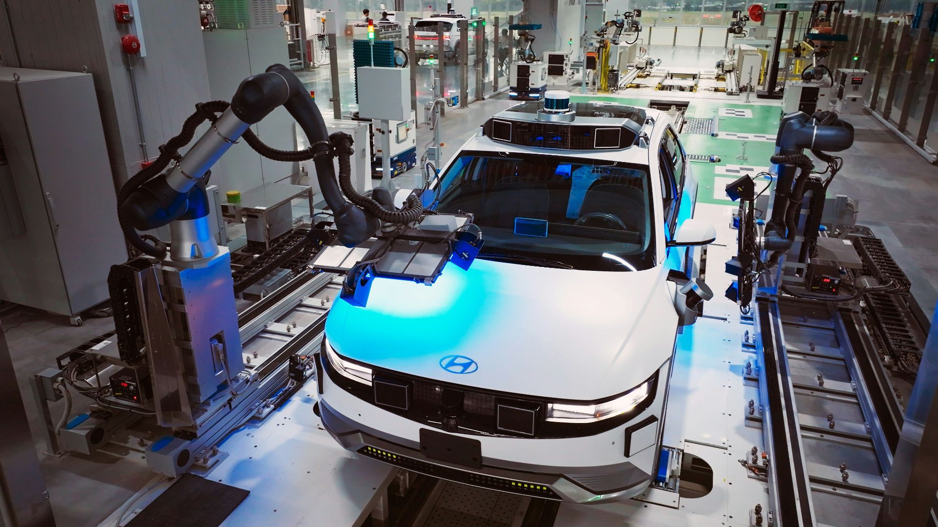 a white car is on a assembly line