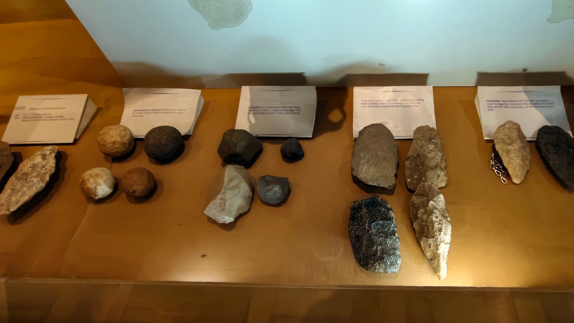 The Oldowan toolkit, the oldest known stone tools dating back at least 2.6 million years, primarily consists of simple hammerstones, stone cores, and sharp flakes used for cutting and chopping.