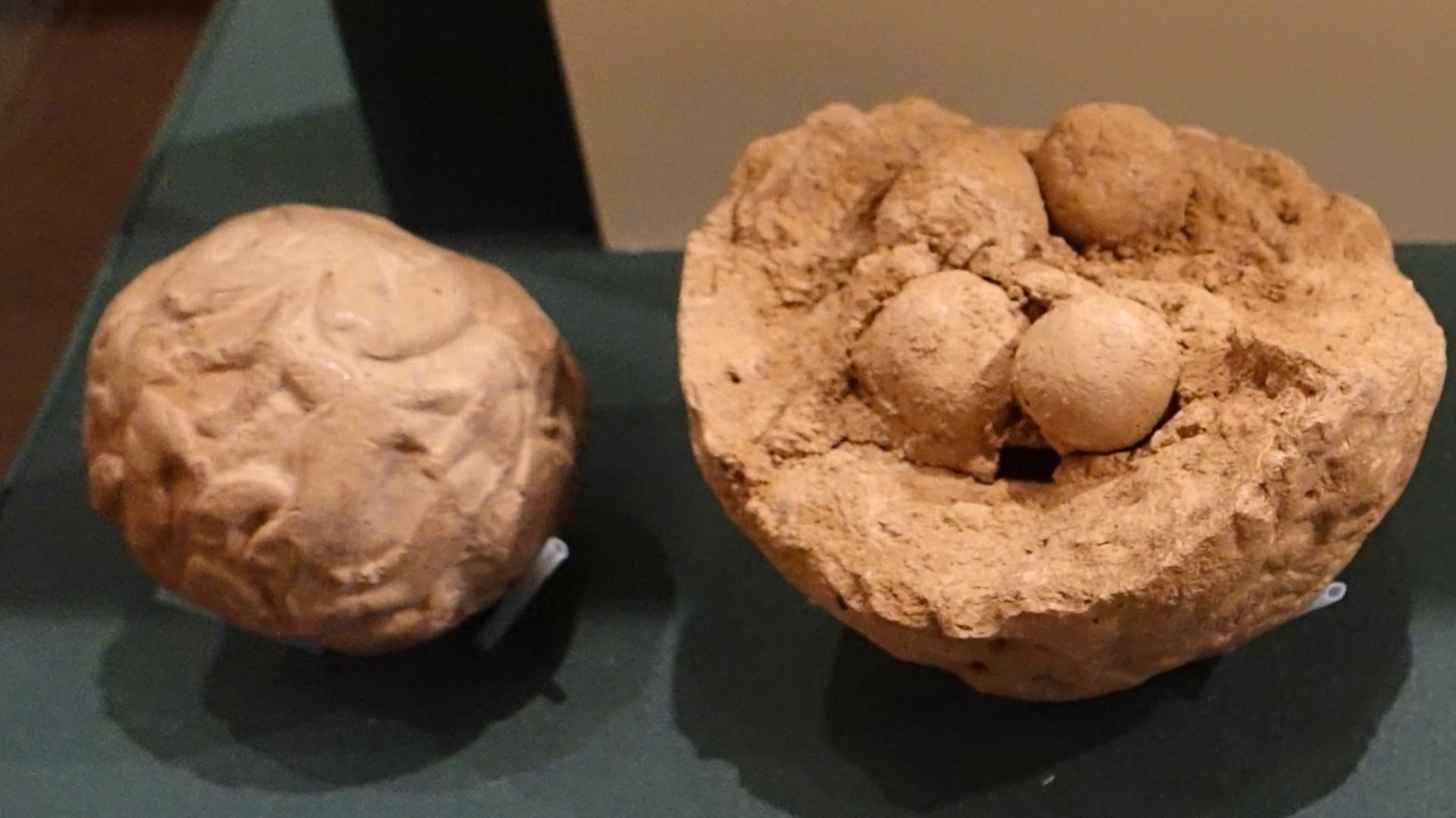 Two clay bullae, one complete and sealed, the other broken with tokens visible, Uruk period. Oriental Institute Museum, Chicago.