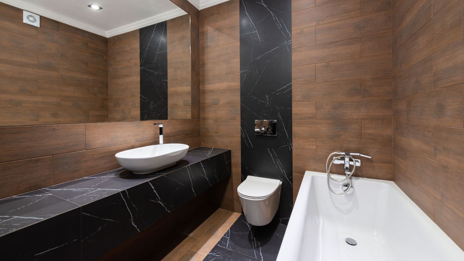 Modern bathroom with wooden accents, sleek fixtures, and minimalist design.