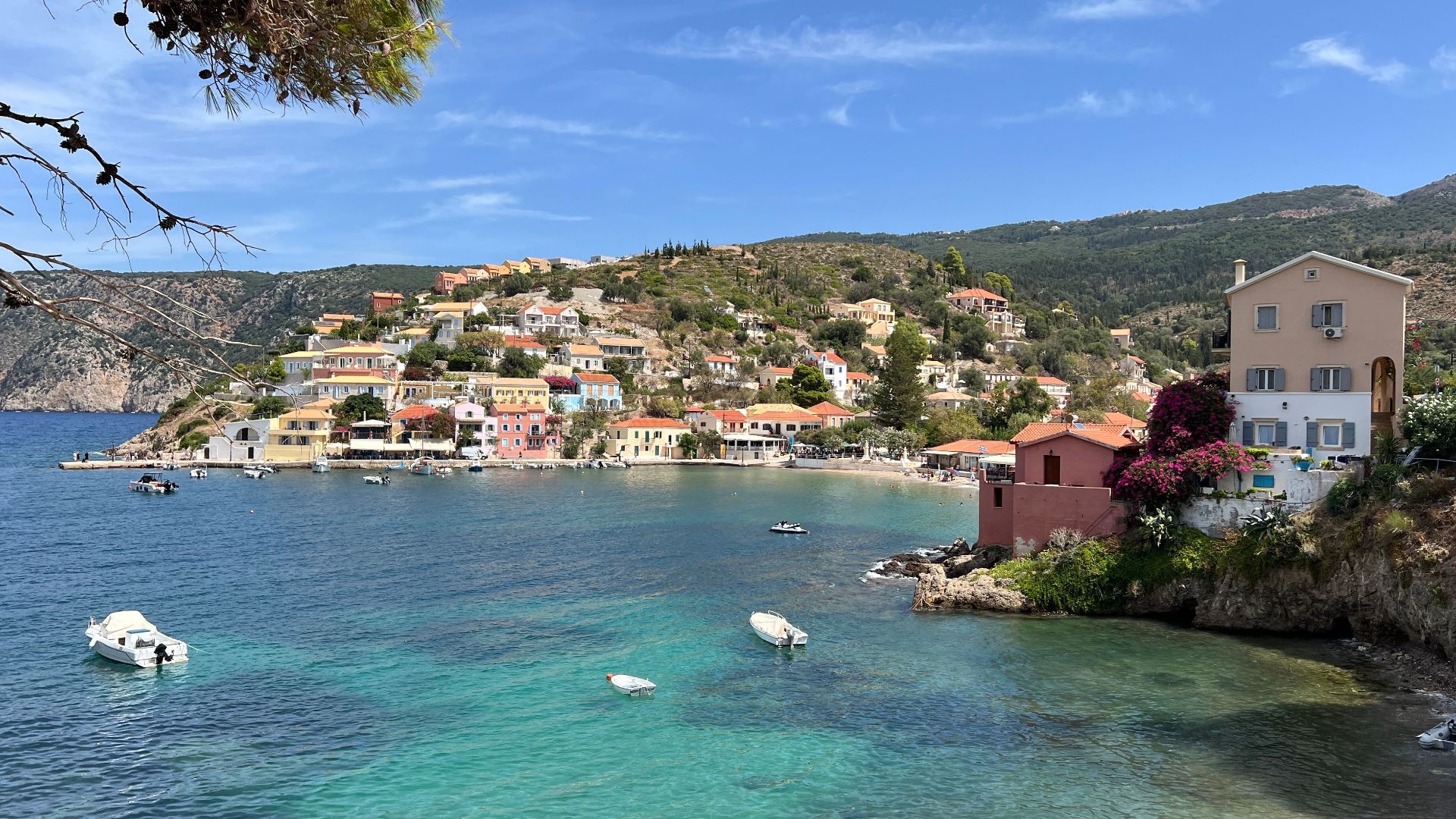 Picturesque coastal village of Assos in Kefalonia with colorful houses and clear sea.