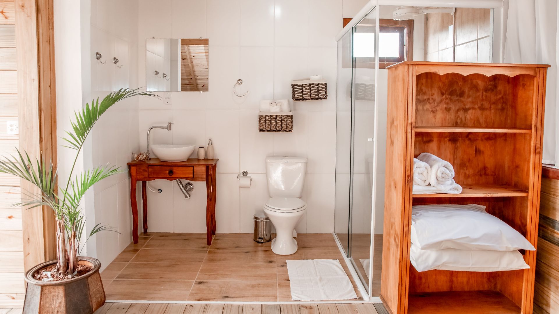Bright and airy bathroom featuring wooden accents and minimalist decor elements.
