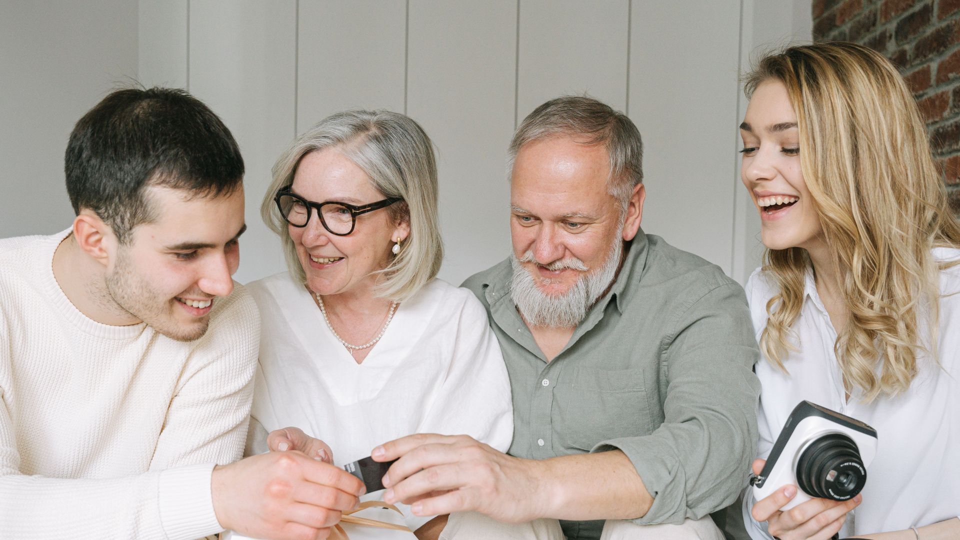 Happy family exchanging gifts together, capturing a joyful moment indoors.
