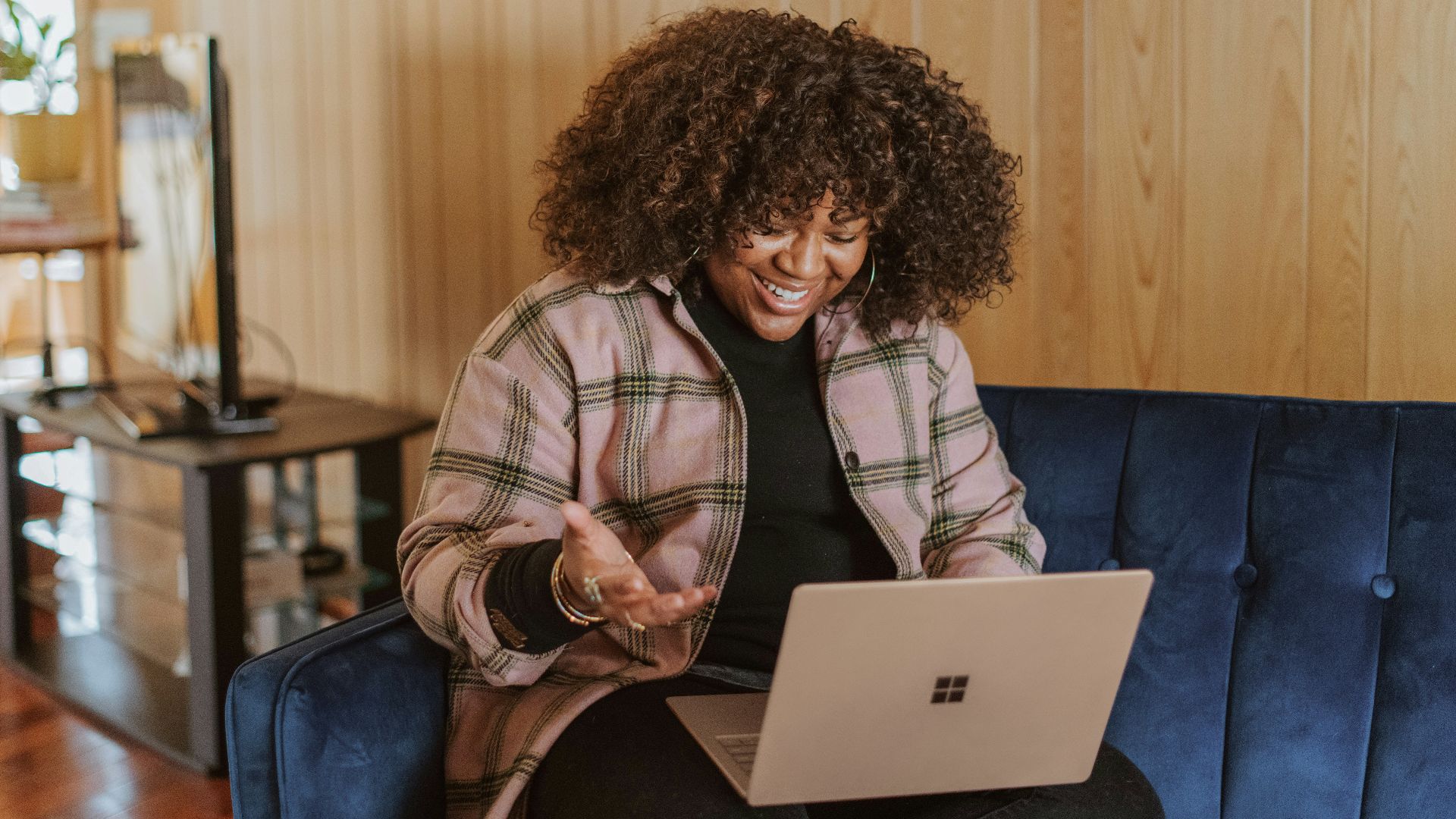 person sitting on couch holding a Surface device