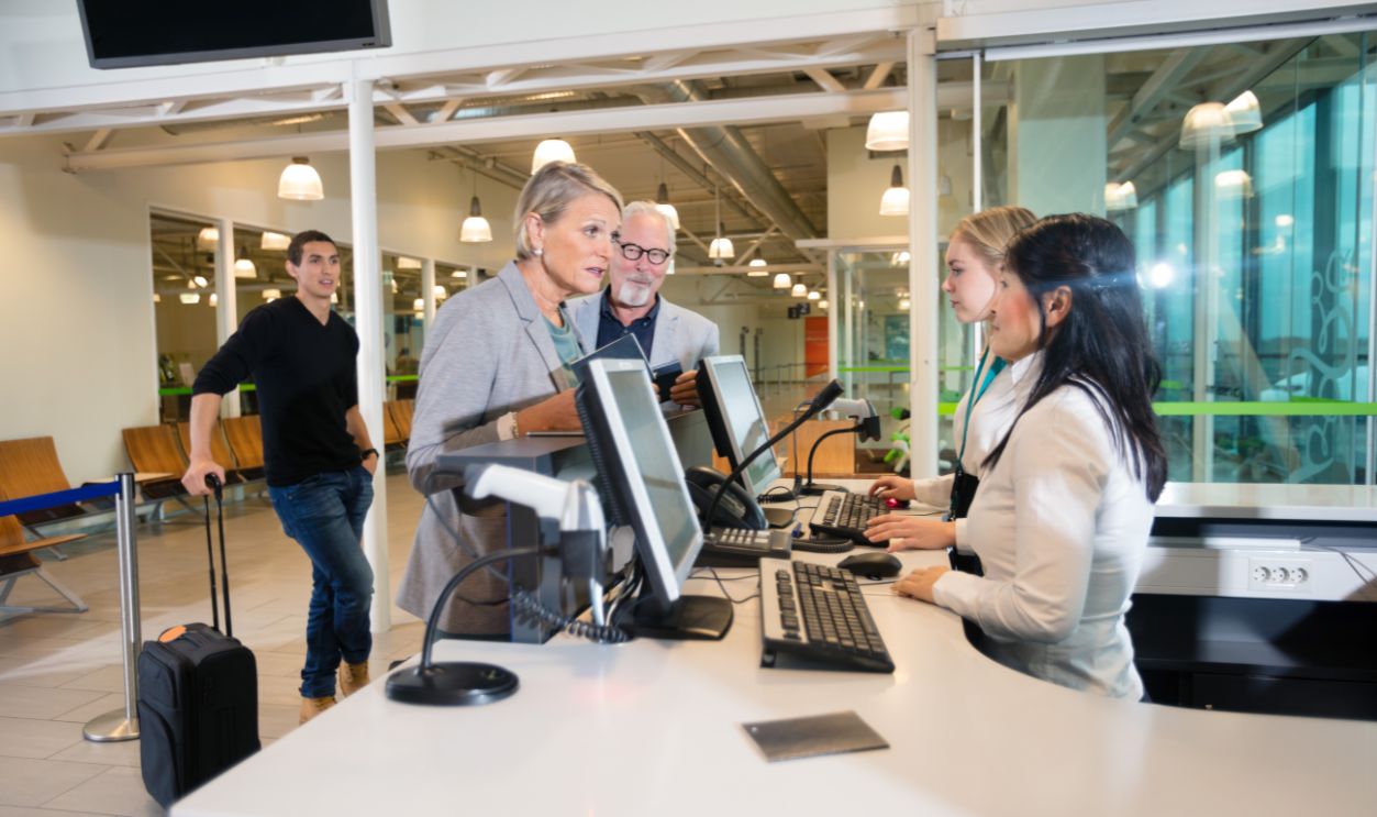 Shutterstock-791231671, Senior Businesswoman Talking With Staff At Airport