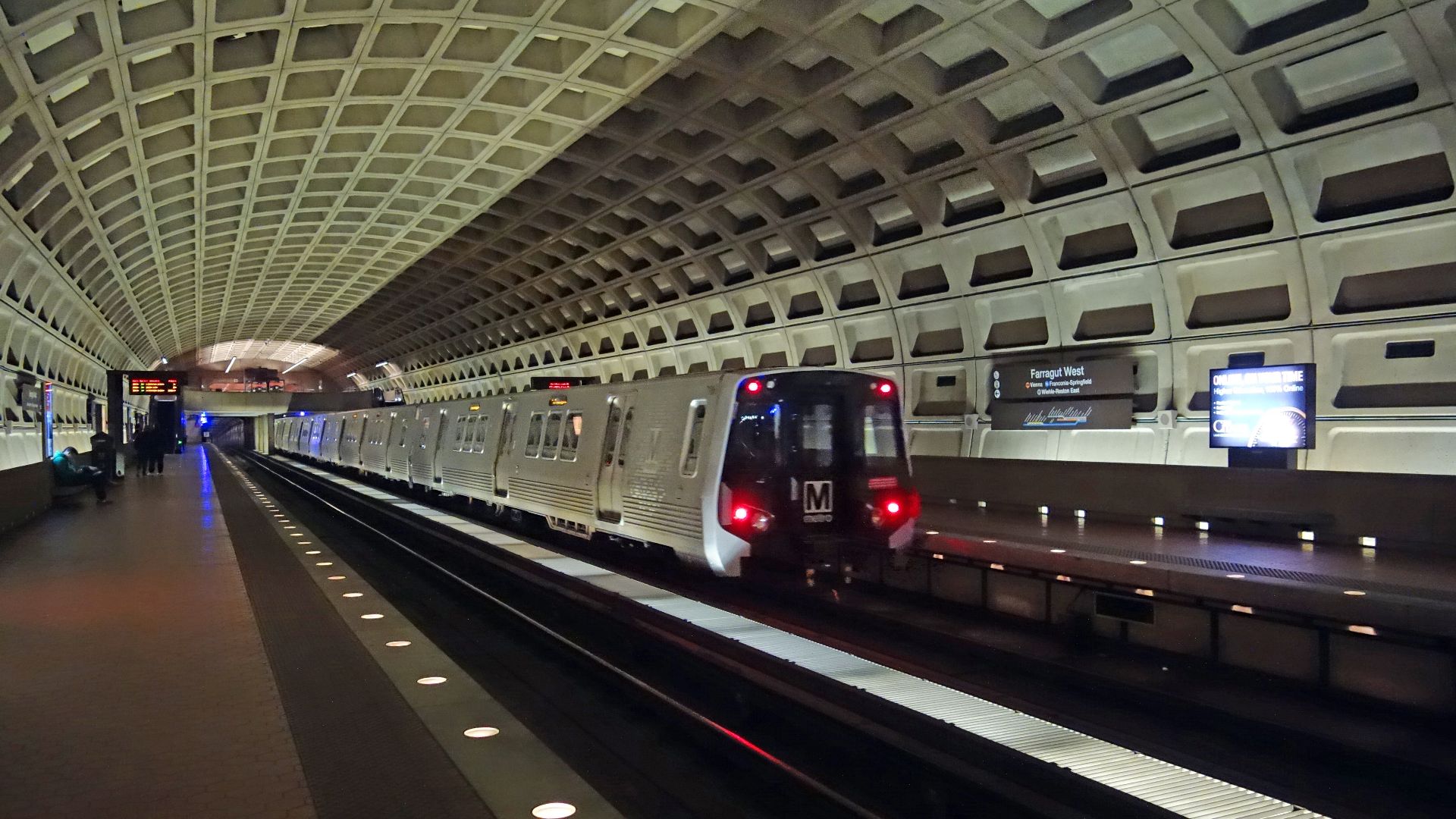 An out of service train bypassing the westbound platform of the Farragut West Metro station, underneath Farragut Square at I Street and 17th Street in Downtown Washington, D.C. Looking from the eastbound platform.