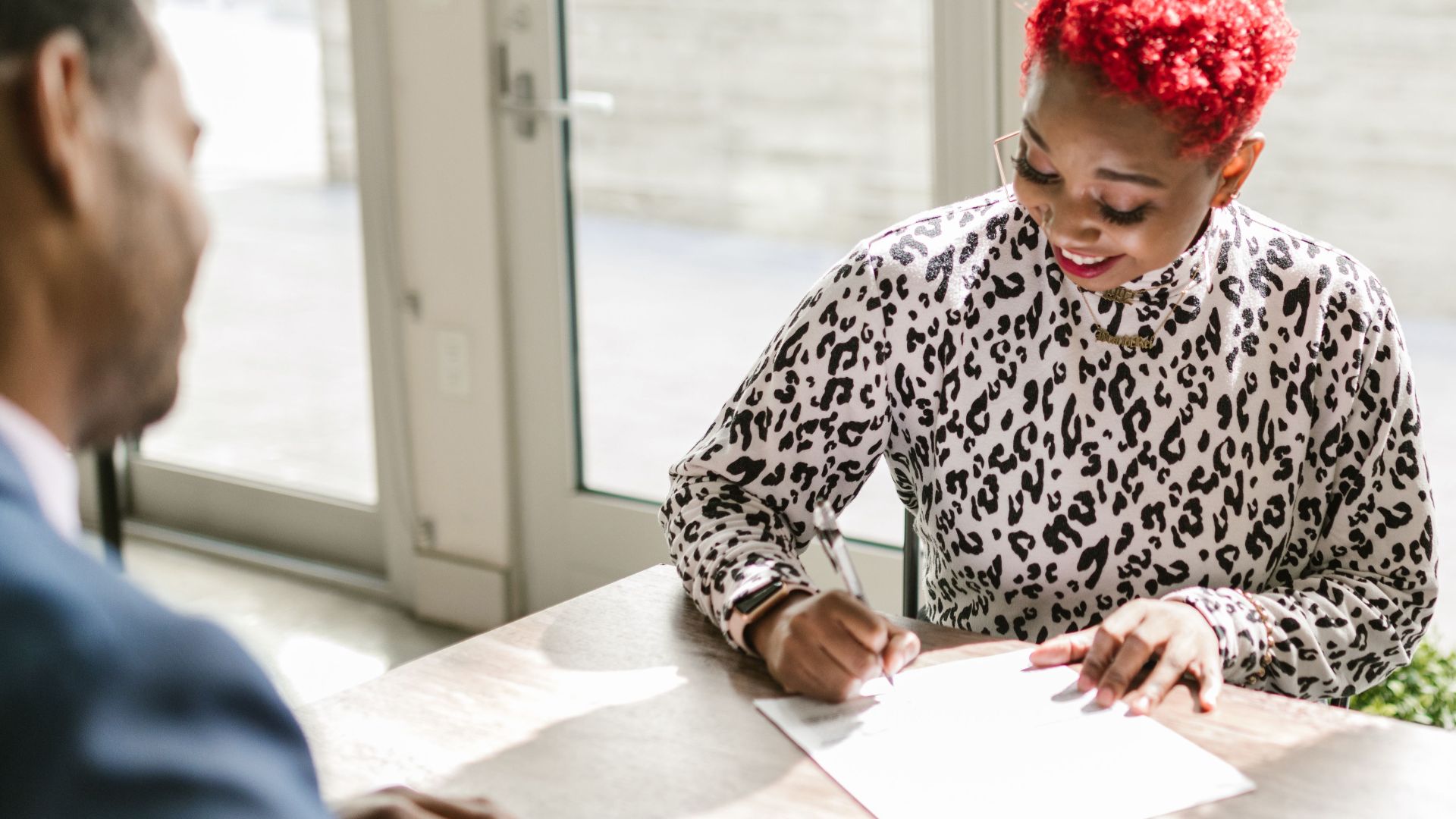 Diverse professionals reviewing documents in a bright, modern office setting.