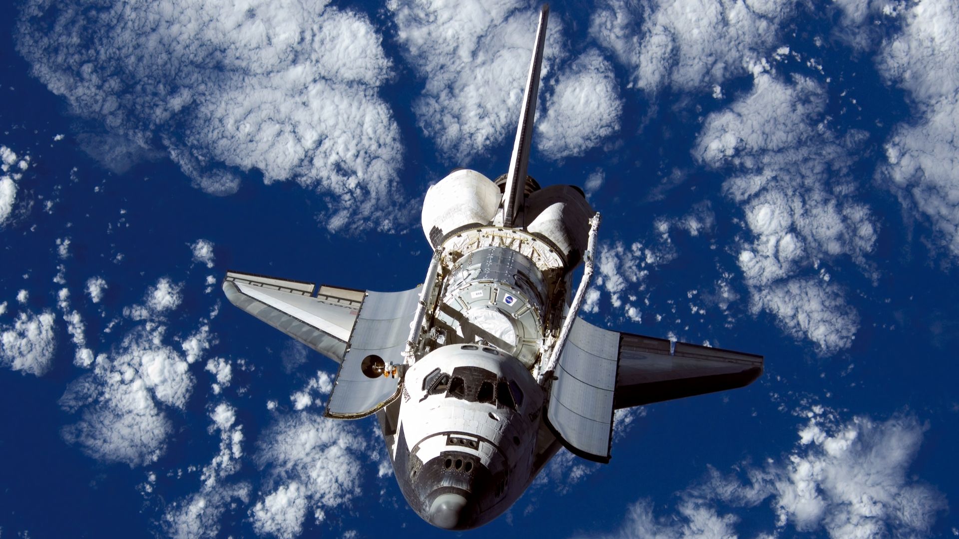 ISS016-E-006331 (25 Oct. 2007) --- Backdropped by a blue and white Earth, Space Shuttle Discovery approaches the International Space Station during STS-120 rendezvous and docking operations. Docking occurred at 7:40 a.m. (CDT) on Oct. 25, 2007. The Harmon