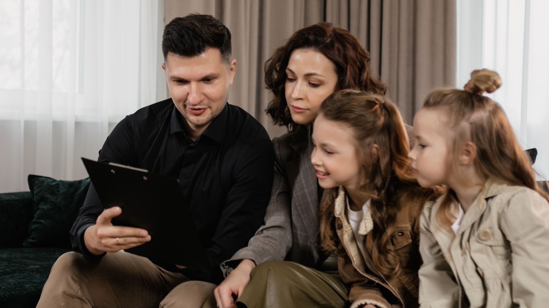 A family receiving advice from a professional advisor indoors, focused on financial planning.