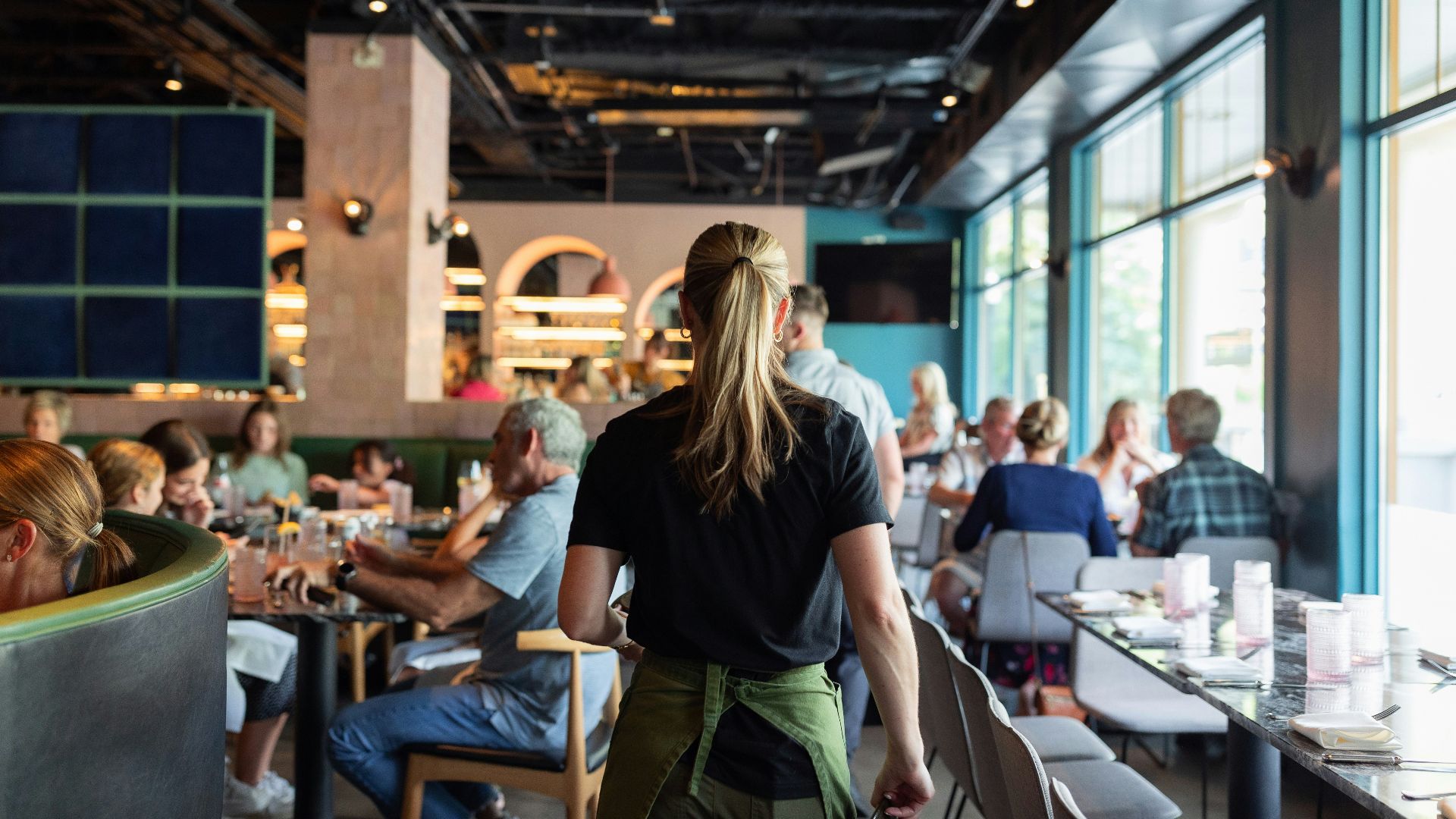A group of people sitting at tables in a restaurant