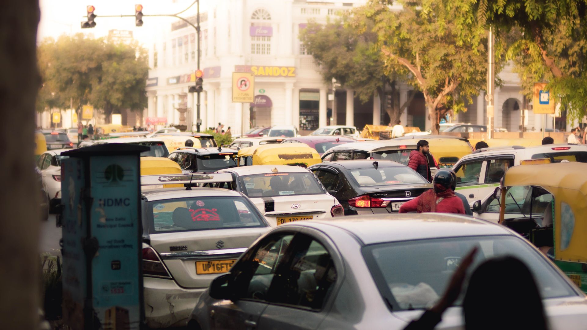 Busy street scene with congested traffic in New Delhi, India. Captured in vibrant daylight showcasing city hustle.