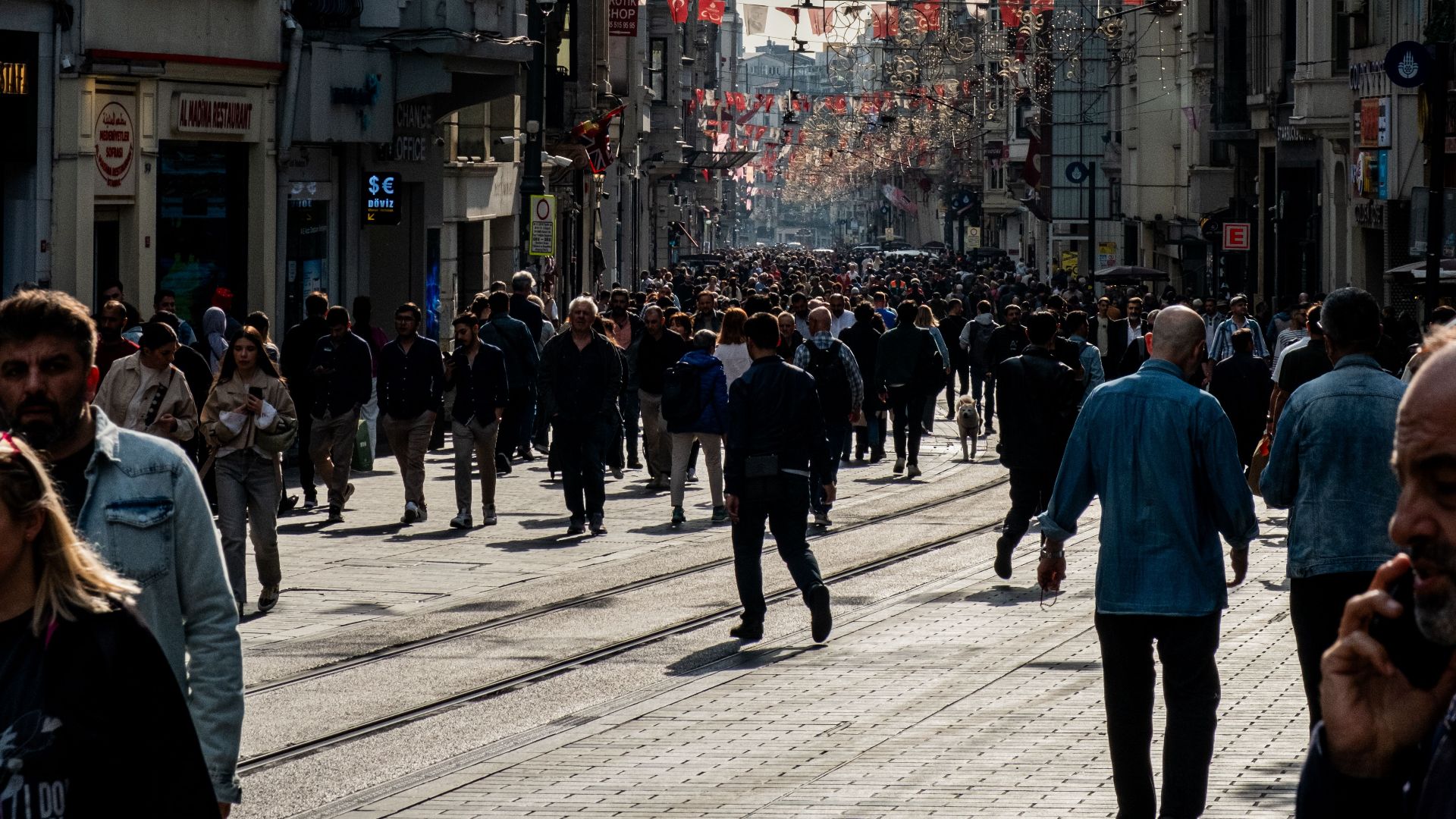 A vibrant street scene in Istanbul, capturing the lively urban atmosphere with a diverse crowd.