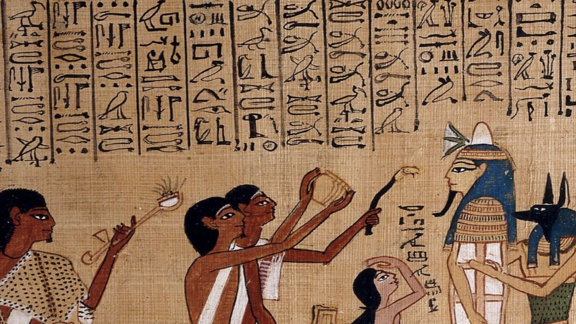 This is an excellent example of one of the many fine vignettes (illustrations) from the Book of the Dead of Hunefer.
The centrepiece of the upper scene is the mummy’s coffin, complete with death mask, of Hunefer, shown supported by the god Anubis (or a pr