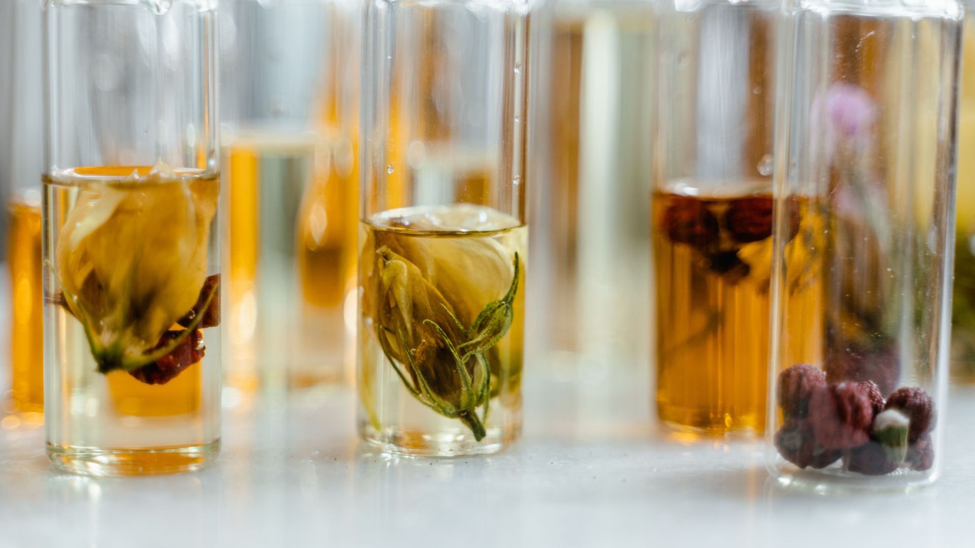 Glass bottles with floral infusions perfect for natural aromatherapy and skincare.